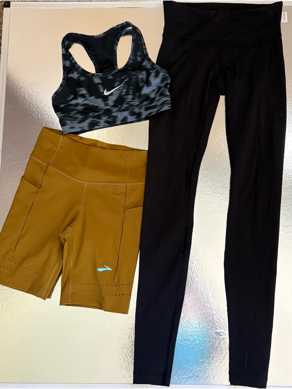 Lululemon black leggings, Brooks mustard running shorts, Nike sports bra